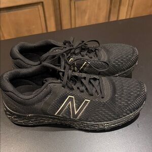 New Balance Black Athletic Running Shoes with Subtle Gold Trim